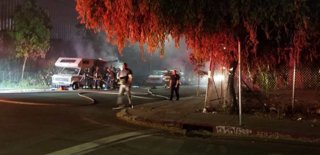 Oakland firefighters extinguish a fire in two RVs reportedly set by masked men in West Oakland on Aug. 2, 2019. Photo courtesy Jessica Brown.